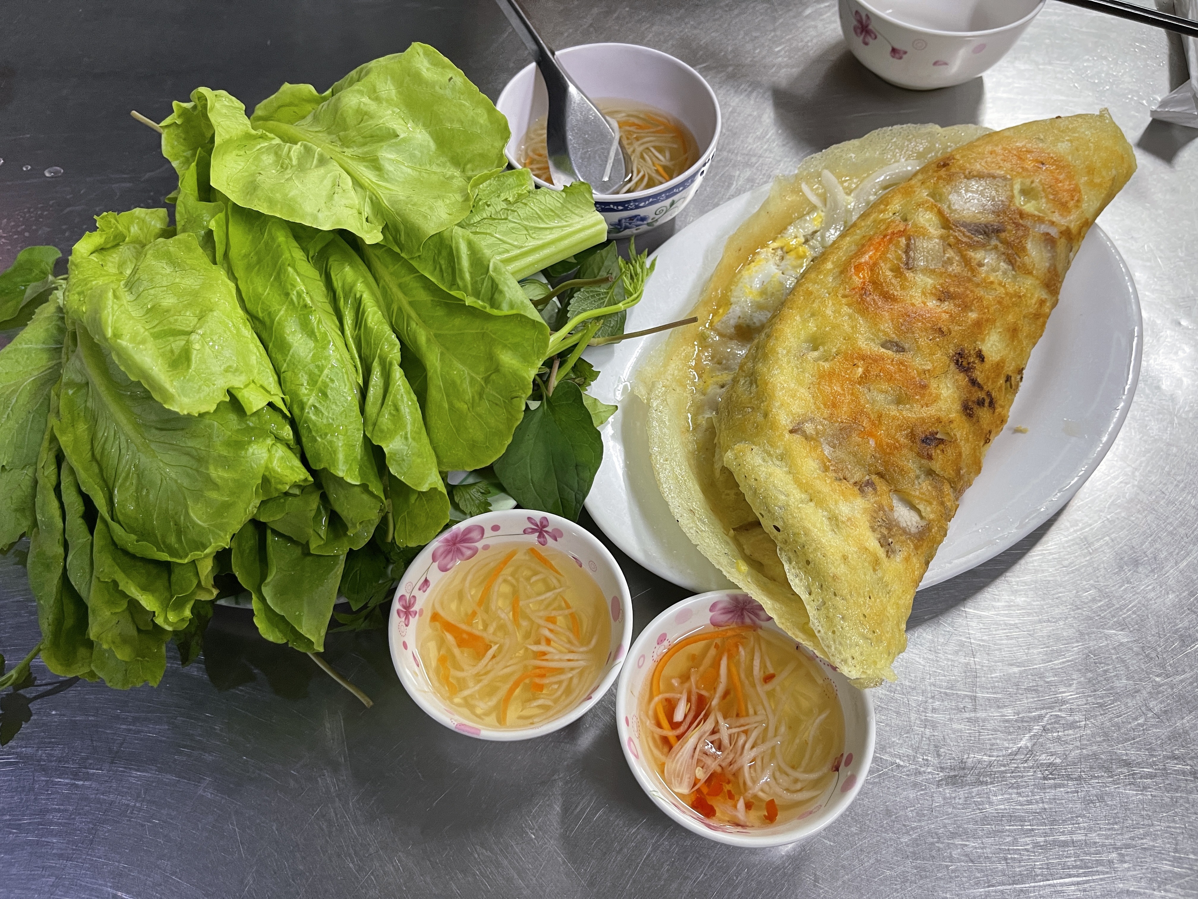 Veggie is served with 'banh xeo' (Vietnamese sizzling savory crepes) at an eatery in District 1, Ho Chi Minh City. Photo: Dong Nguyen / Tuoi Tre News