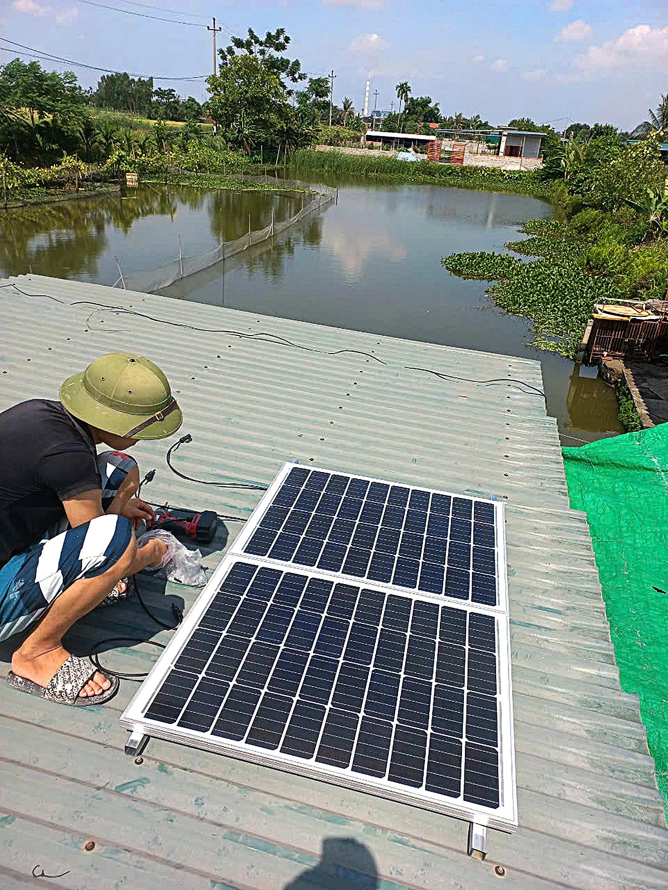 Nguyen The Dien installs a solar panel system for his customer. Photo: Tam Le / Tuoi Tre