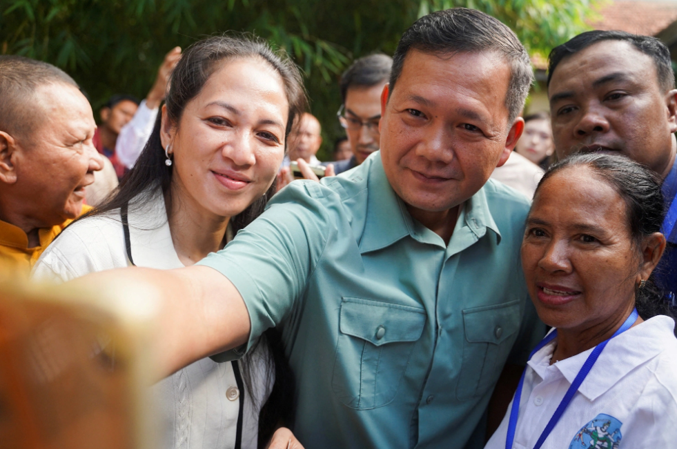 Hun Manet, son of Cambodian Prime Minister Hun Sen, takes a photo with voters on July 23, 2023. Photo: Reuters