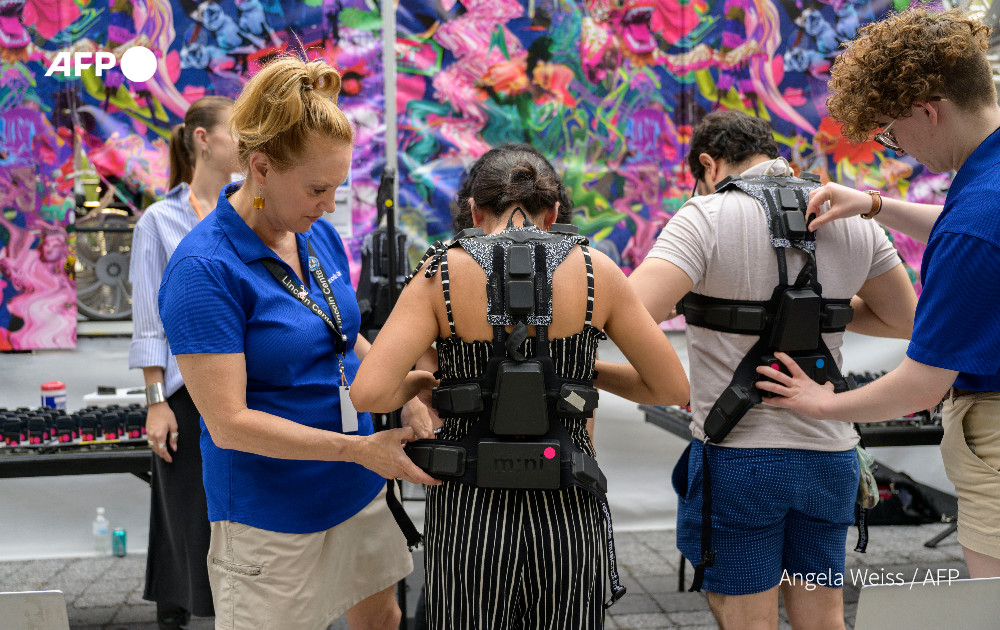 Concertgoers get fitted for haptic suits created for the deaf by Music: Not Impossible, during an outdoor concert at Lincoln Center on July 22, 2023, in New York City. Photo: AFP