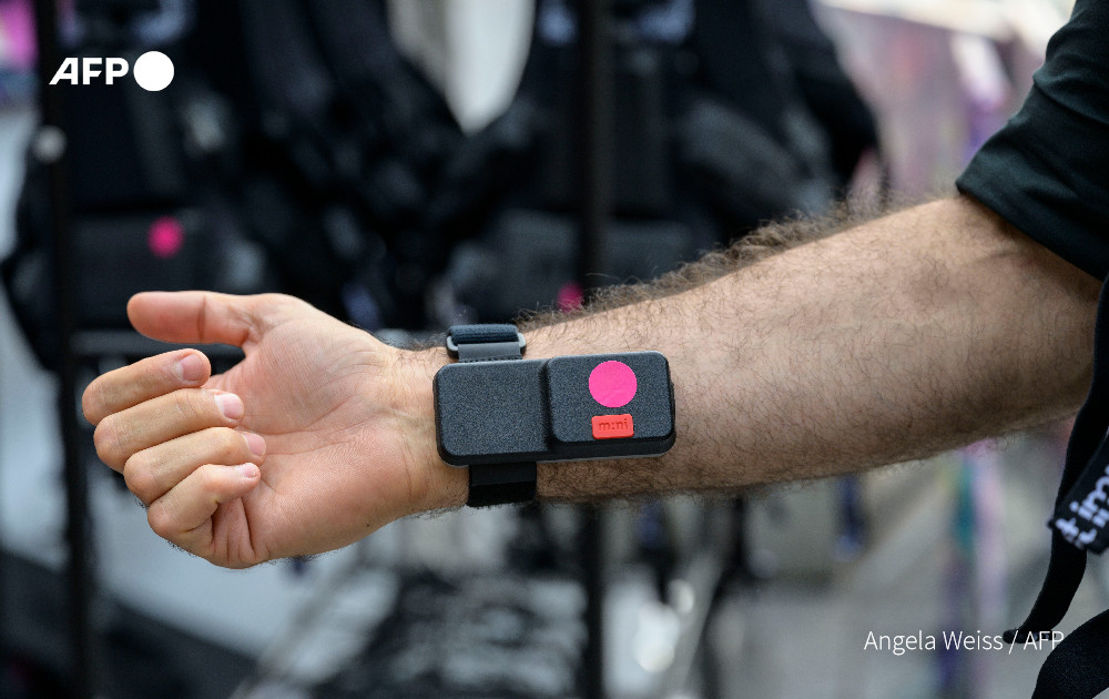 A concertgoer wears a vibrating wristband, part of a haptic suit, created for the deaf by Music: Not Impossible, during an outdoor concert at Lincoln Center on July 22, 2023, in New York City. Photo: AFP