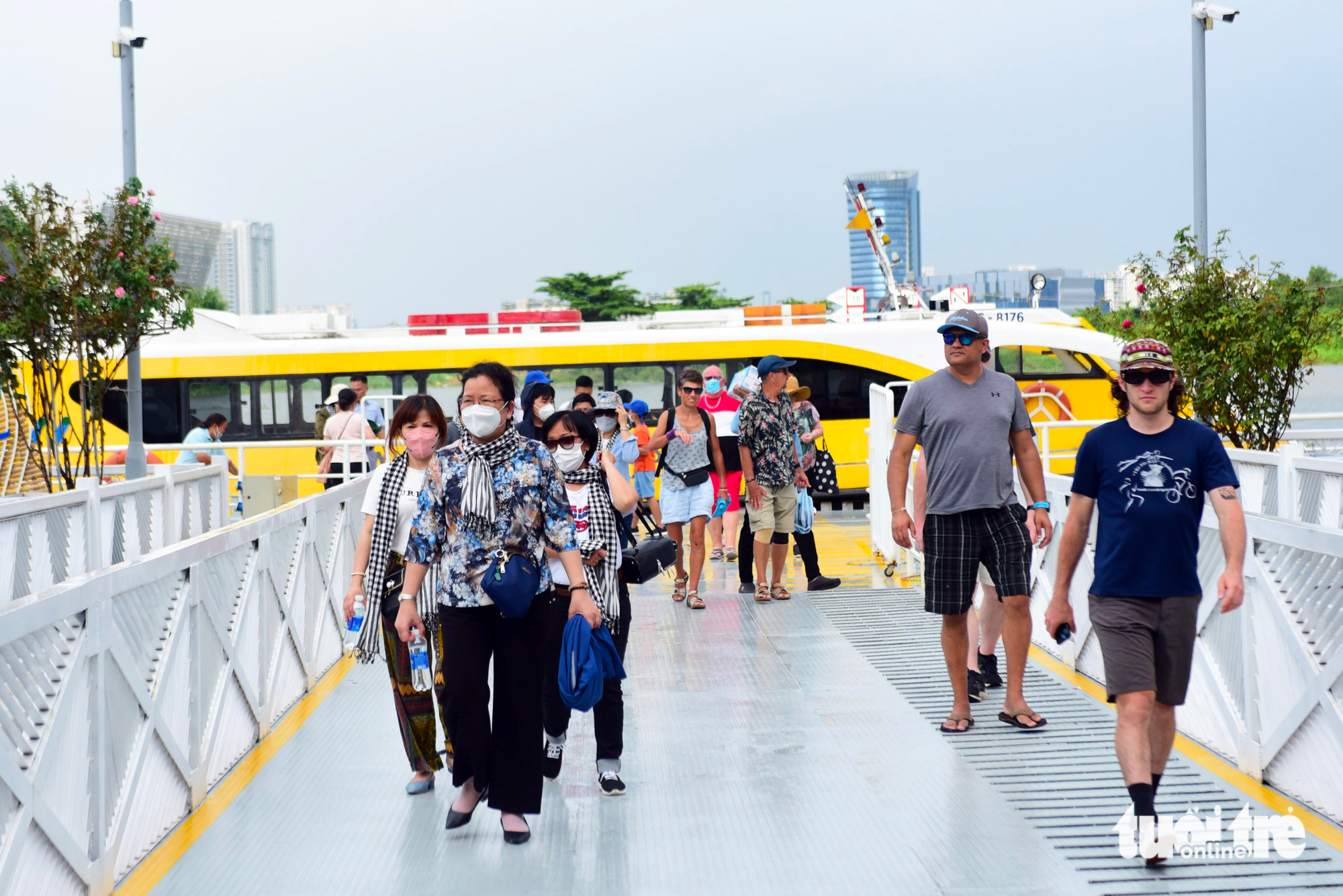 Domestic and foreign tourists disembark after a water bus trip in Ho Chi Minh City. Photo: Duyen Phan / Tuoi Tre