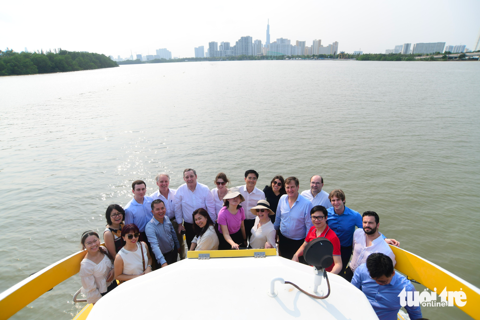 A group of passengers poses for a photo while taking a water bus trip on Saigon River in Ho Chi Minh City. Photo: Quang Dinh / Tuoi Tre