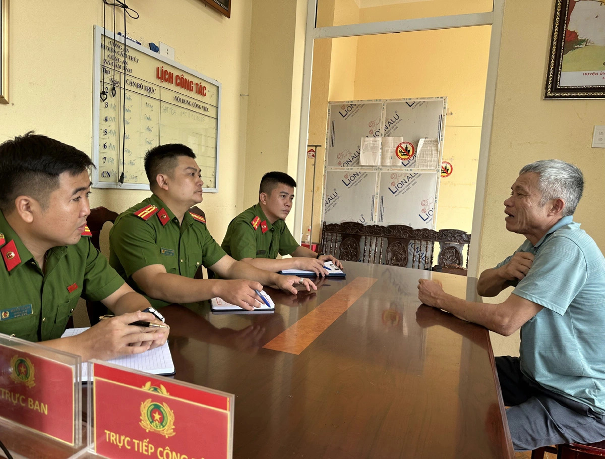 Nguyen Manh Hung, who leased a plot of agricultural land where the illegal mining operation took place, is questioned by police officers in Thanh Hoa Province, north-central Vietnam. Photo: Supplied