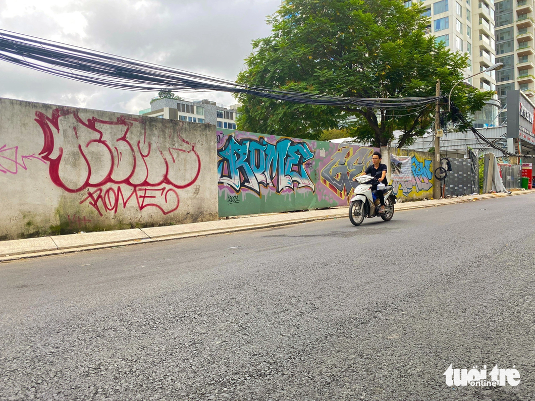 Vandals also smear a fence at the foot of the bridge with graffiti.