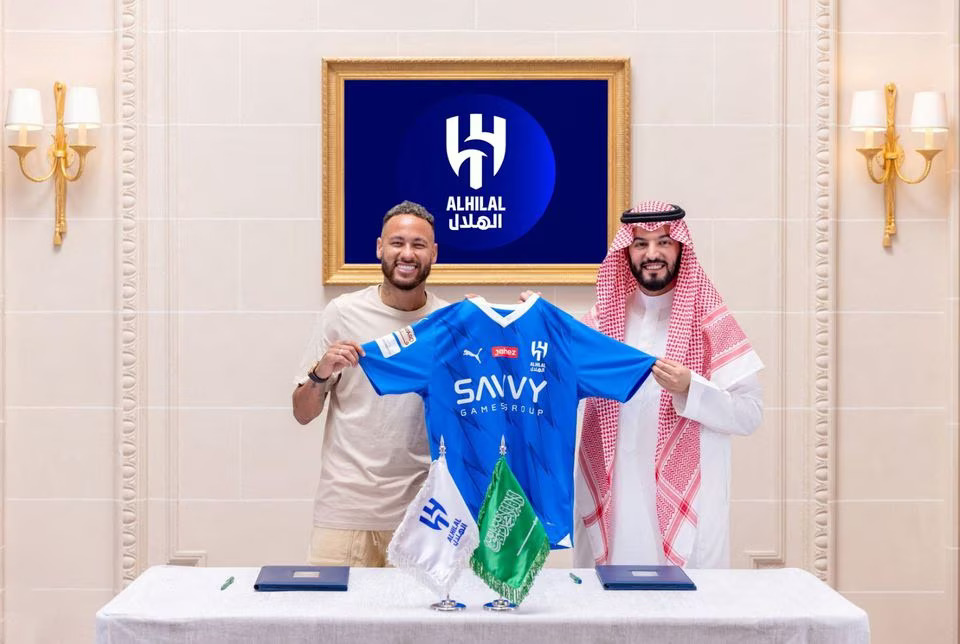 Soccer Football - Neymar signs for Al Hilal - Paris, France - August 15, 2023. Al Hilal's new signing Neymar holds their shirt as he poses with President Fahd bin Saad Al-Nafel Saudi Pro League. Photo: Reuters