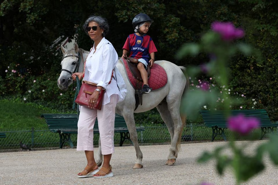 A child takes a pony ride on the Parc Monceau as the city of Paris is introducing a ban on pony-riding starting from 2025 after the animal protection association, Paris Animaux Zoopolis warned of shortcomings in animal welfare in Paris, France, August 16, 2023. Photo: Reuters