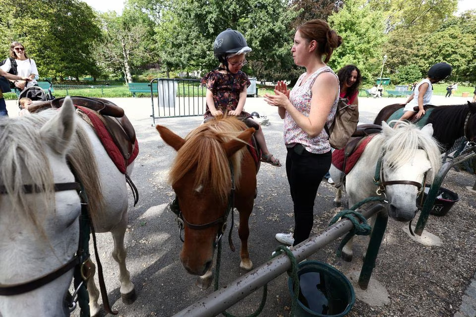 A child takes a pony ride on the Parc Monceau as the city of Paris is introducing a ban on pony-riding starting from 2025 after the animal protection association, Paris Animaux Zoopolis warned of shortcomings in animal welfare in Paris, France, August 16, 2023. Photo: Reuters