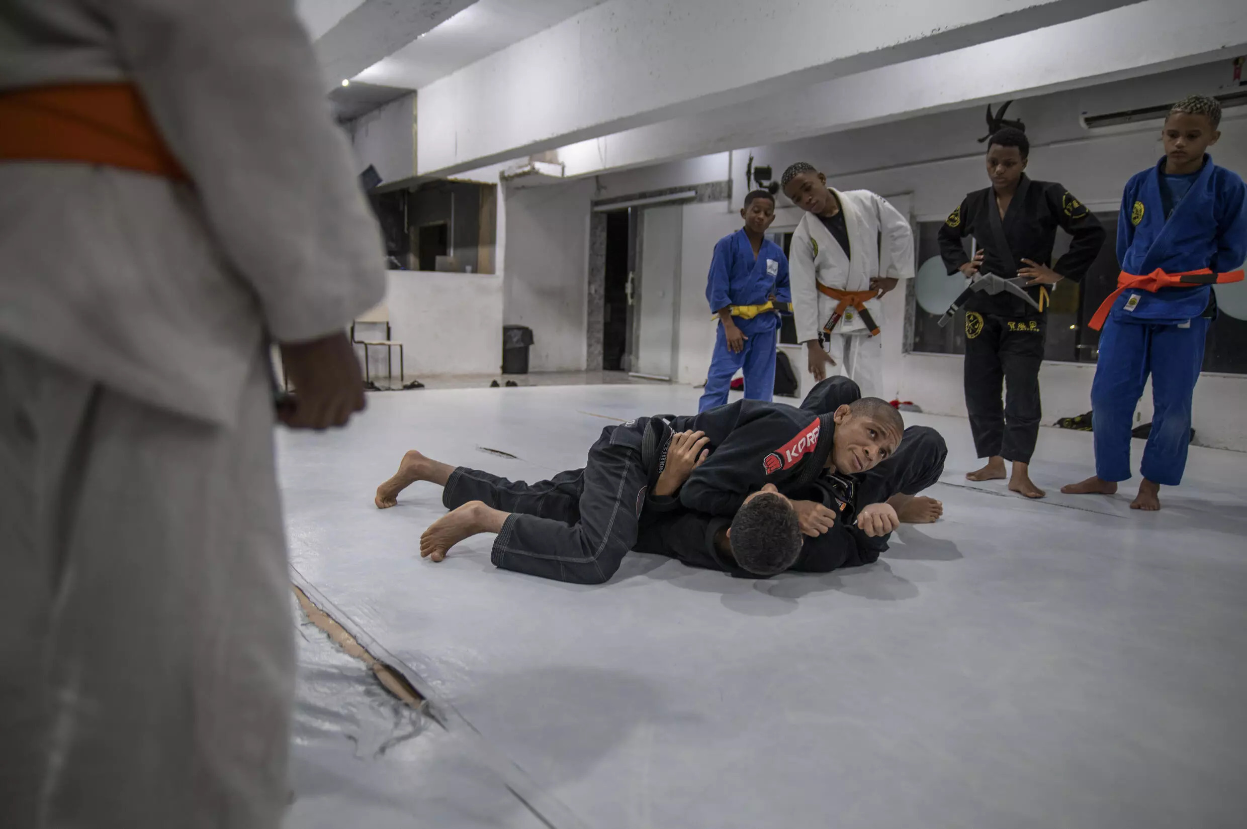 Brazilian Jiujitsu instructor Douglas Rufino shows a lock to his students. Photo: AFP