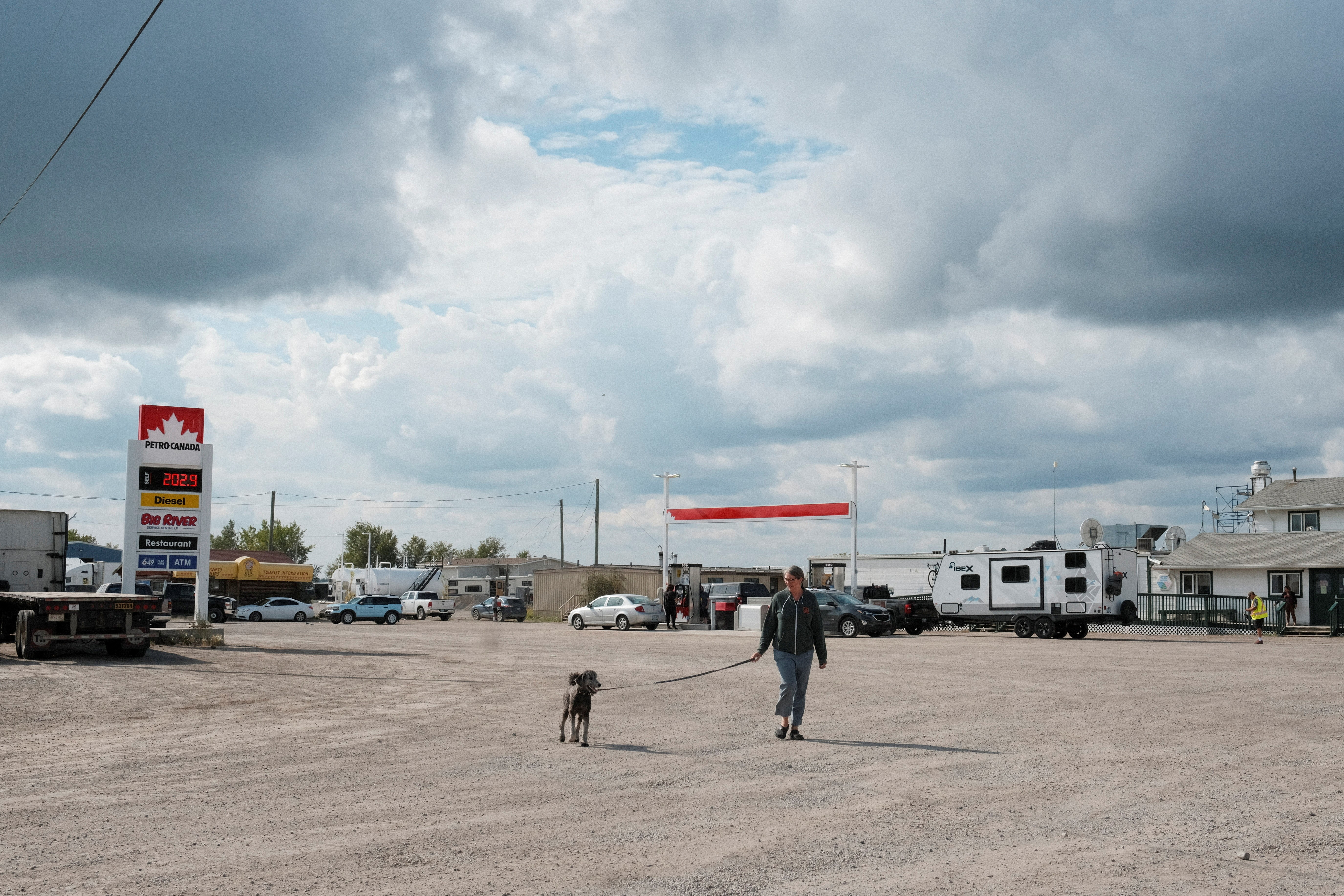 Sarah Carr-Locke walks her dog while waiting for fuel in Fort Providence, after an evacuation order was declared due to the proximity of a wildfire in Yellowknife, Northwest Territories, Canada August 17, 2023. Photo: Reuters