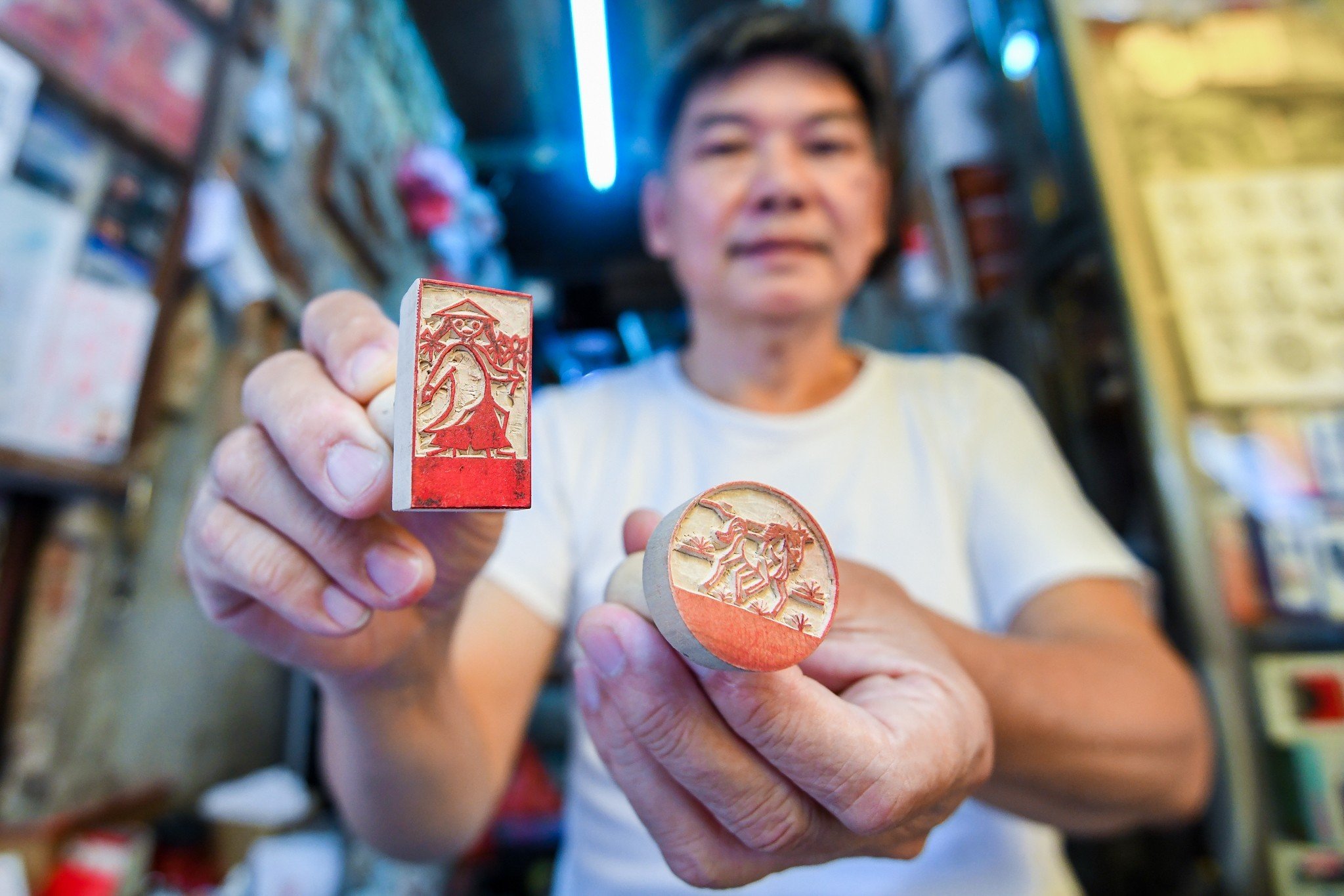 Toan holds two of the wooden stamps he made. Photo: Nam Tram / Tuoi Tre News
