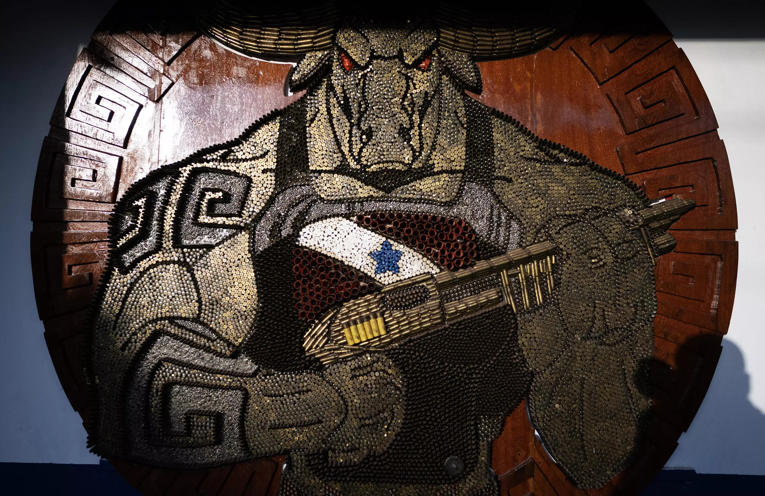 The Soure military police unit's headquarters is adorned with a plaque made of bullet casings depicting a muscular buffalo holding a shotgun. Photo: AFP