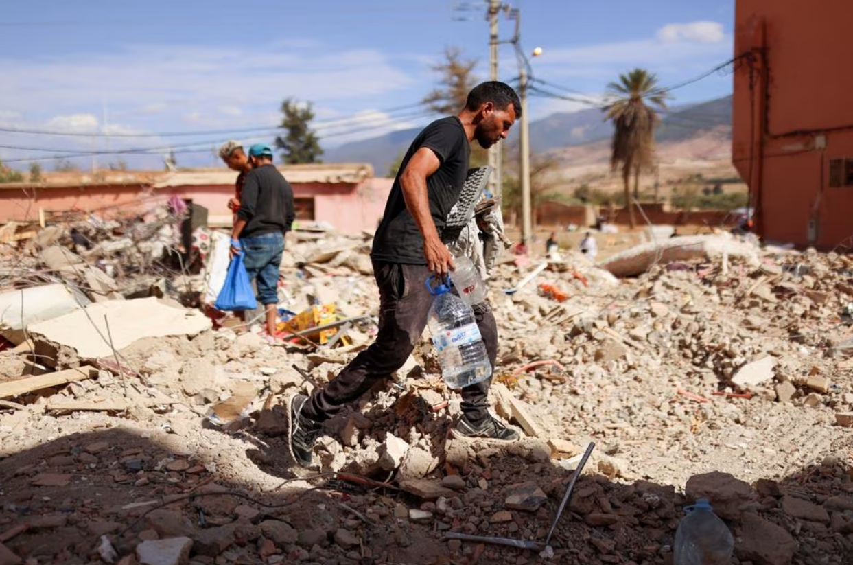 A man walks on the rubble as people look on, in the aftermath of a deadly earthquake, in Amizmiz, Morocco, September 10. Photo: Reuters