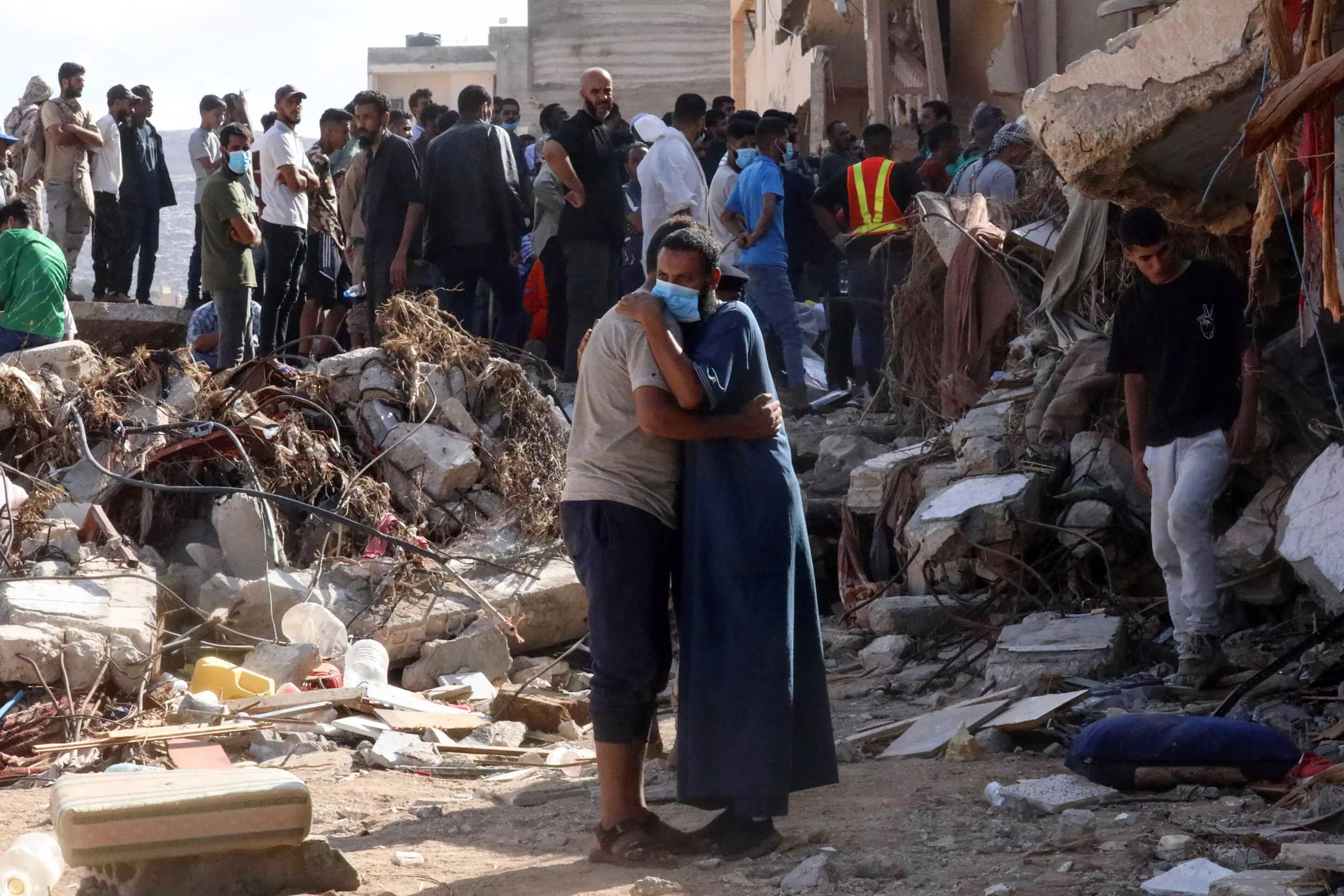 Residents search mangled buildings for missing loved ones and bulldozers clear streets of debris and mountains of sand. Photo: AFP