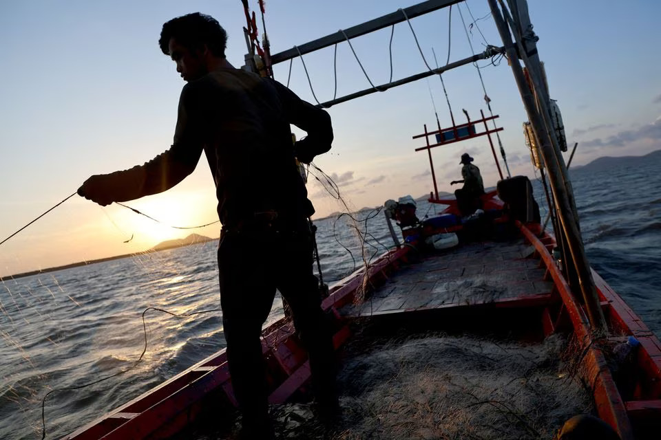 Fisherman Ung Bun, 39, works on his boat out at the sea off the coast of Cambodia's southern Kep Province, August 18, 2023. Photo: Reuters