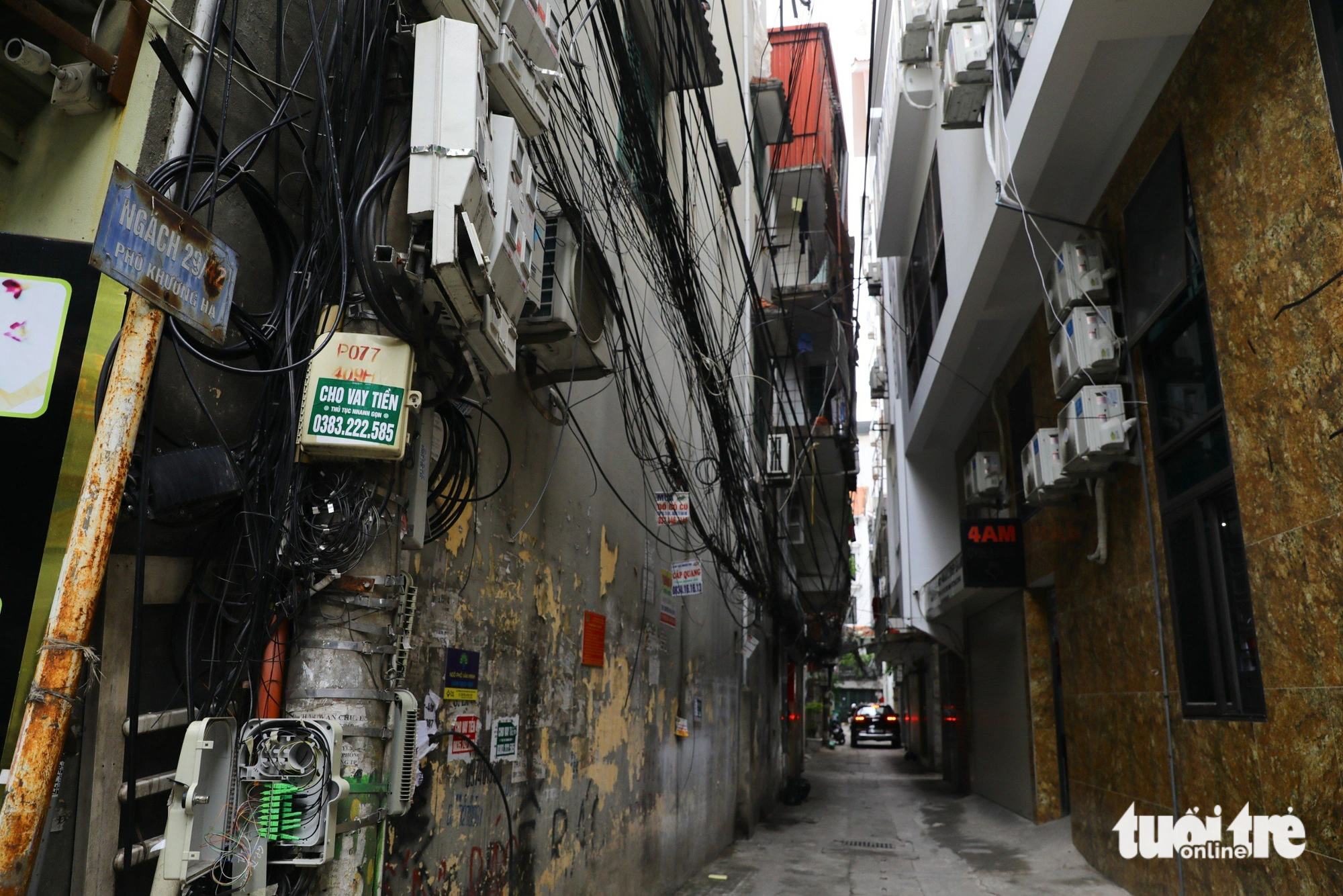 Many condenser units for air conditioners are installed outside an apartment block on a little alley on Khuong Ha Street in Hanoi. Photo: Danh Khang / Tuoi Tre