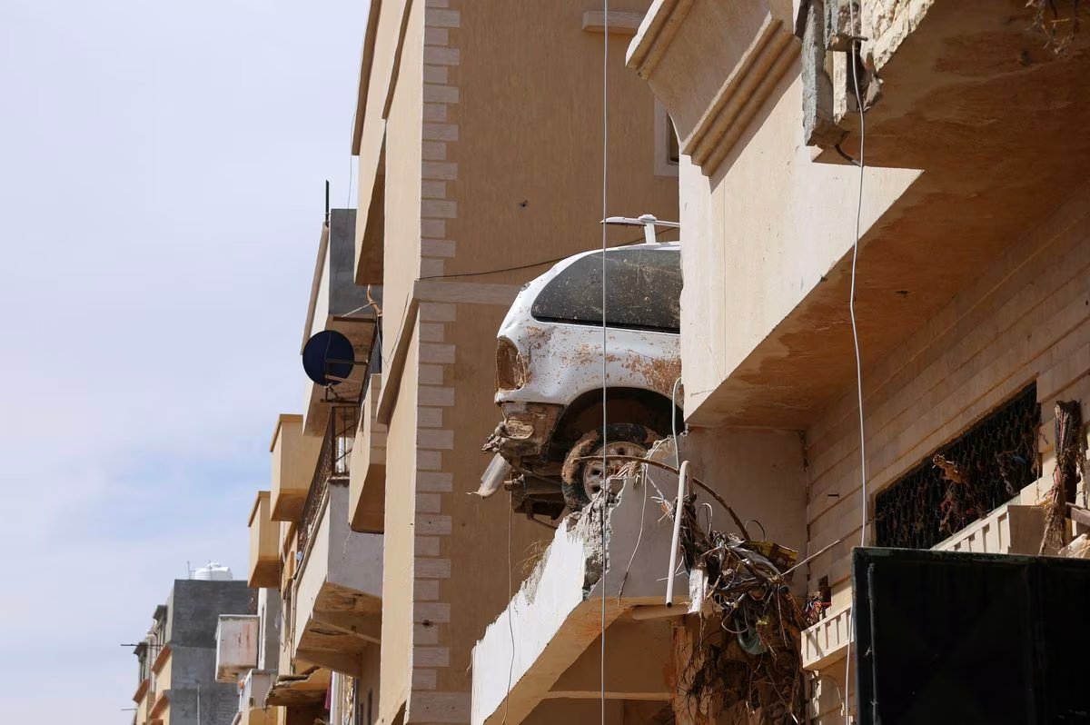 A destroyed car sits on top of a residential building following fatal floods in Derna, Libya, September 17, 2023. Photo: Reuters