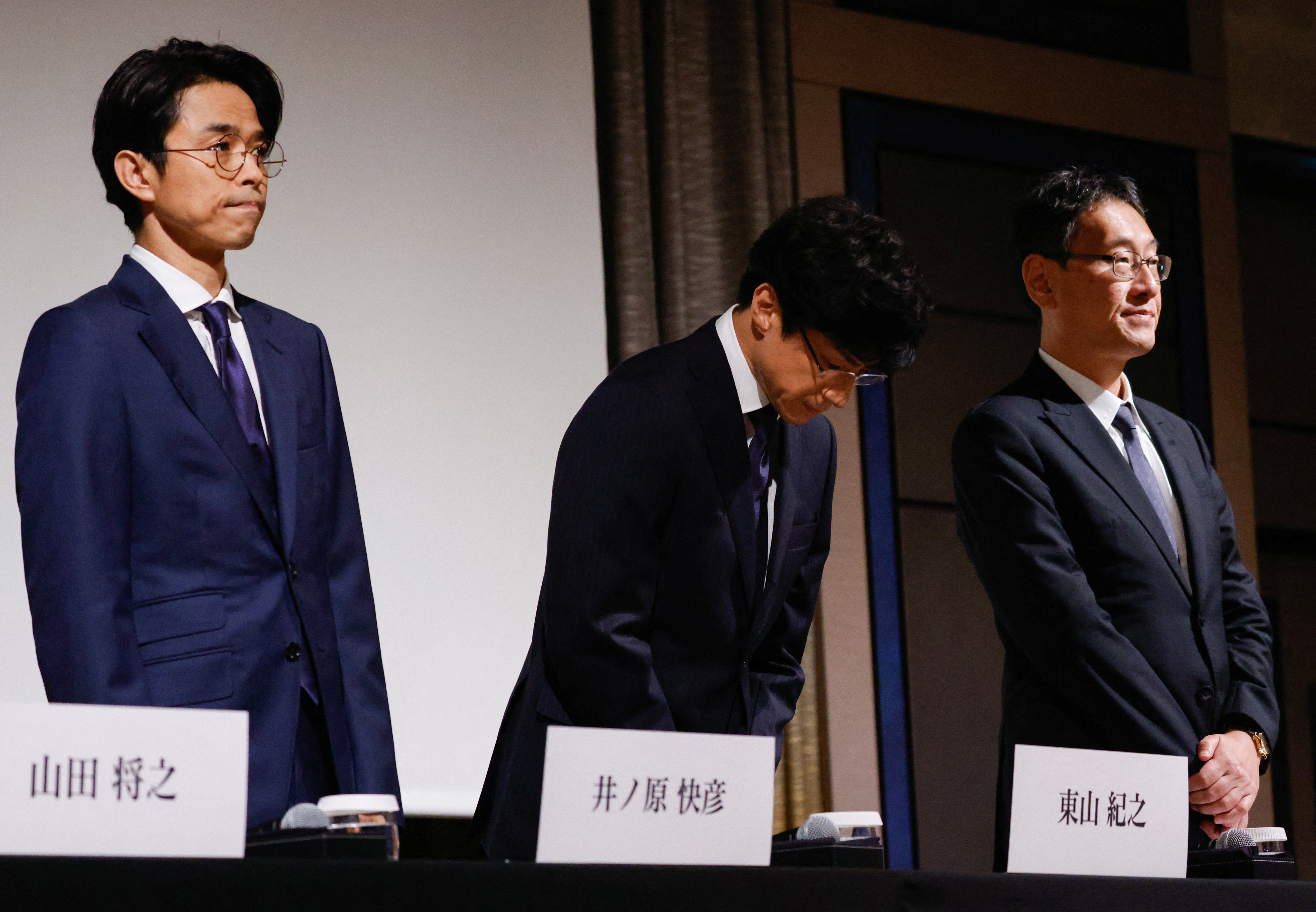 Japan's talent agency Johnny & Associates Chief Noriyuki Higashiyama, flanked by CEO of Johnny's Island Yoshihiko Inohara and their lawyer Hiroshi Kimeda, bows at the start of their news conference in Tokyo, Japan, October 2, 2023. Photo: Reuters