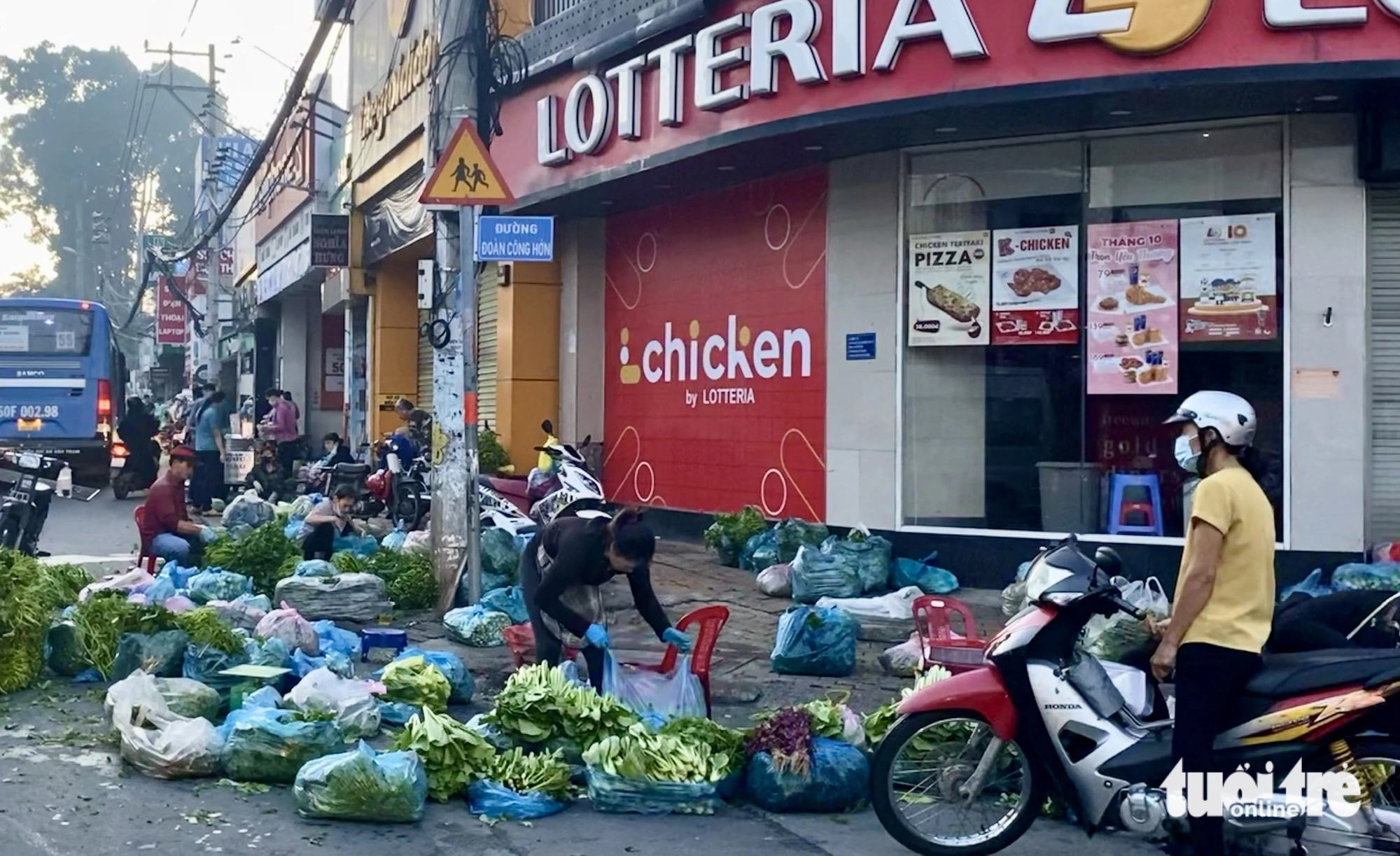 Vendors offer their vegetables packed in plastic bags for sale at a wet market in Thu Duc City under Ho Chi Minh City