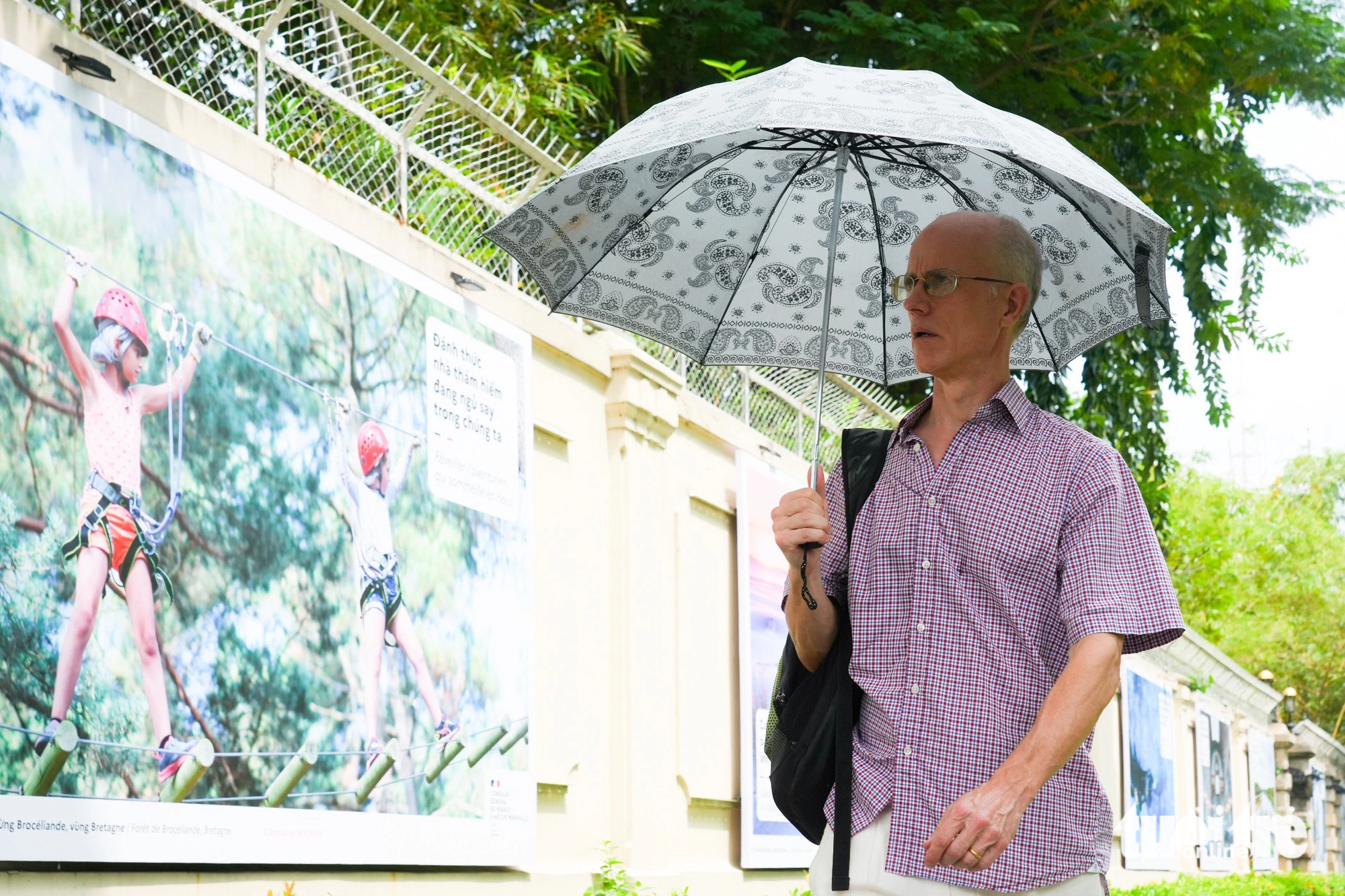 A man walks by photos at the French Residence in District 1, Ho Chi Minh City. Photo: Hai Quynh / Tuoi Tre
